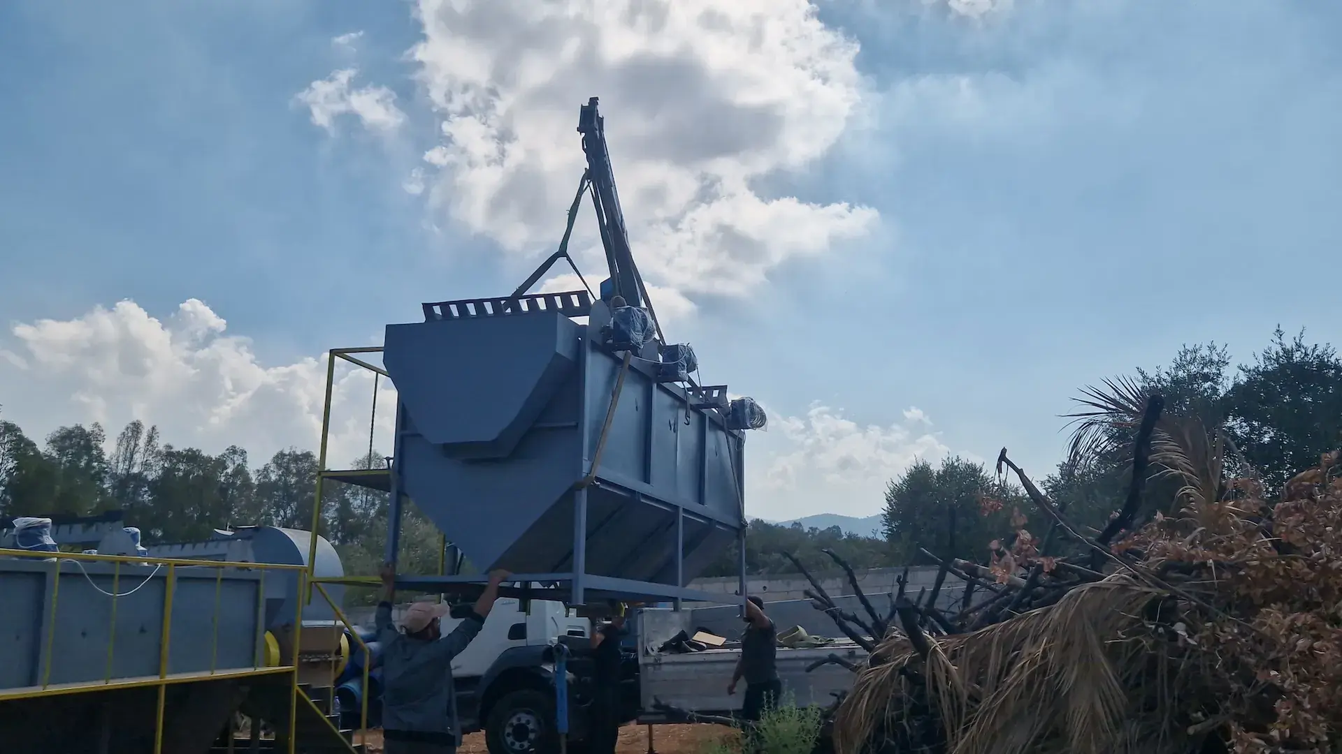 Sayed Transport loading heavy industrial machinery with the truck-mounted crane