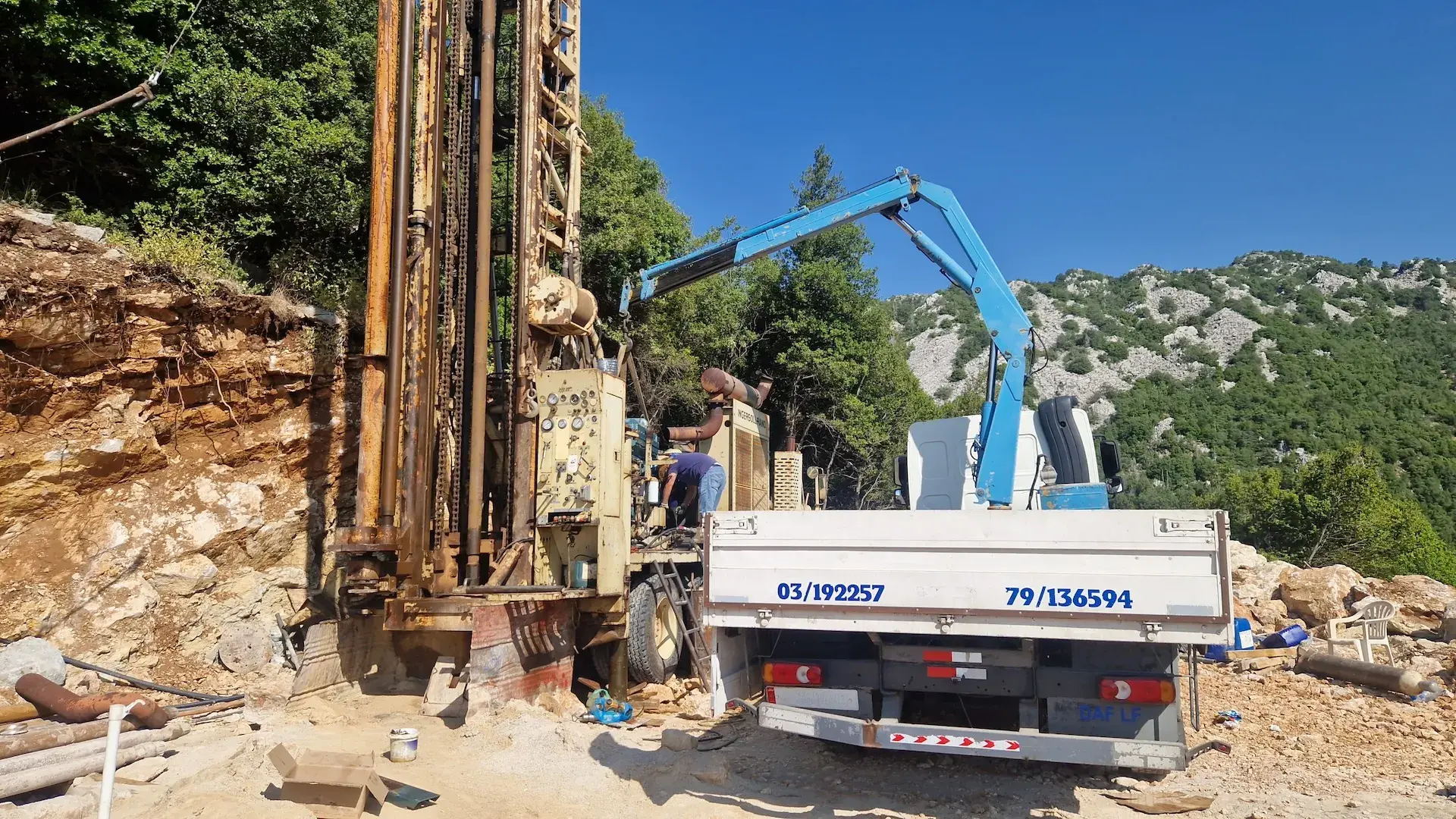 Sayed Transport loading heavy industrial machinery with the truck-mounted crane